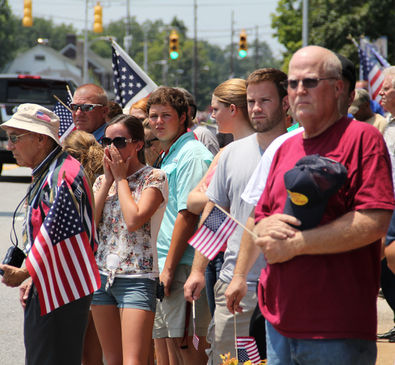 Thousands wave flags, salute Pfc. Adam Ross upon his return home
