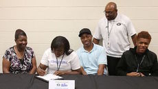 Brishauna Wright signs a national letter of intent to participate in track at Limestone College. Left to right are Cathy Wright, mother, Bradley Wright, father, and Blake, brother. Coach Erie Williams is in the background.
 