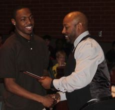 D'Anta Fleming receives the Special Teams Player of the Year award from assistant coach Erie Williams.