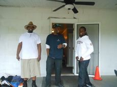 Brothers Darron Moore (left), Spencer Talley (right) and lifetime friend Rod Rogers arrived well before dawn to set up for today’s yard sale. They were enjoying the story of Dynamite’s signature laugh that defined his personality.