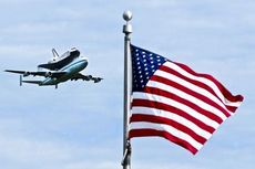 The space shuttle Discovery attached to its 747 transport aircraft passes over Washington, D.C., on its final flight today.