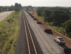 Railroad cross ties are stacked and grading has been completed in preparation for the laying of a second set of Norfolk and Southern tracks on the east end of the Inland Port.