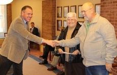Nick Stegall, left, Greer CPW General Manager, announced his retirement today at the board of commissioners meeting. In this photo Stegall congratulates a customer who won a drawing in a CPW promotion earlier this year.