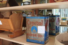 An antique gas can shows its label, 113, preceding the auction at ACME General Store.