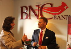 Blair Miller, BNC City Manager, chats with a visitor to the bank's Handshakes and Hashbrowns event for greater Greer business associates.
 