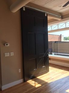 One unit features a barn door between the living and sleeping space.