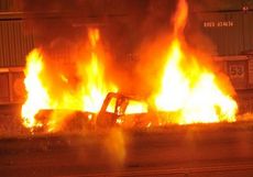 A 2005 Ford Ranger is engulfed in fire Saturday night after being hit by a Norfolk Southern train on Hwy. 290 and near the overpass on J. Verne Smith Parkway.