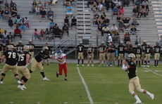 Greer quarterback Mario Cusano (11) eyes a target downfield. Cusano threw for 230 yards and four touchdowns. (Photo gallery by Grace Davis)
 