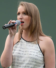 Megan Watts sang the National Anthem at Fluor Field Thursday night. Watts, Greer Idol Teen in 2013, performed during one competition as GreerToday.com streamed her performance to Afghanistan where her father watched and his unit was given a shout out by those attending.
 