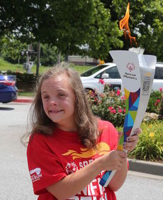 Special Olympian Natalie Dopp was given the honor having Greer's torch lit at City Park.