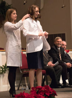 Kathryn E. Allen, 2016 NGU graduate from Sumter, is being cloaked during the NGU PA Medicine White Coat Ceremony on Friday.
   