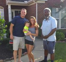 Chris Brown, right, a letter carrier for the U.S. Postal Service in Greer, is being credited with saving the life of infant Eli Cooper from suffocating. Parents John and Stephanie Cooper call Brown's response a miracle.
 