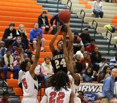 A Greer player has a bead on the basketball as he jumps over three Bryson players Saturday.