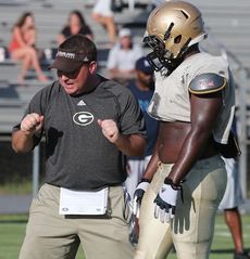 Running backs coach Jay Abercrombie explains techniques during Tuesday's scrimmage.