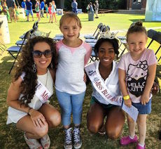 Anna Brown, Miss Greater Greer, and Shiobhan Faser, pose with little girls at the Scottish Games who may also aspire to be a beauty queen.
 