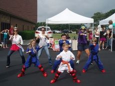 Lauren and Sydney were shown some karate moves from some young students of the discipline at Praise Cathedral’s yard sale for Relay for Life.