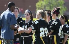 The senior powder puff team is focused on Josh Gentry’s instructions during Thursday’s game at Dooley Field. The seniors won giving Gentry, an outstanding quarterback last year, an undefeated coaching record in powder puff football.