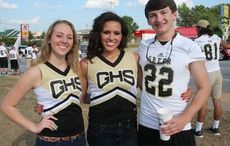 Carly McCall, Brooke Freeman (center) and Adam Burgess took a break from flagging down cars.
 