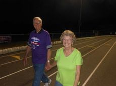 Harriet and George Stram stroll around the track as the luminarias were lit.
 