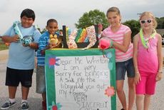 With toy snakes wrapped around their shoulders, the children left no imagination what the subject of their book was during Friday's parade at Crestview Elementary.
 
