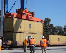 A rail car gets double stacked at the Inland Port.
 