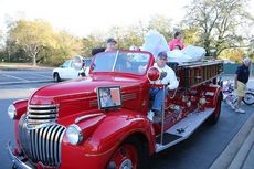 The 1941 pumper fire truck that originally belonged to the Greer Fire Department has been restored. It's first mission was to take the contributed toys and bikes to a secure place. Driving is Gerald Davis and the passenger is Don Lester, a retired 36-year volunteer fireman.
