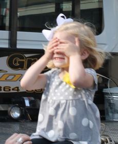 Carol Garrett, 3, shielded her eyes from photographers capturing her roaming on the back of a tow truck.