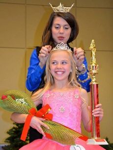 Heather Daniel Cox, 11, is all smiles as she is crowned the winner in her age group by Miss Greater Greer Lanie Hudson.