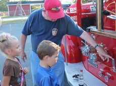 Gerald Davis explains some of the gauges and instruments to children.
 