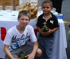 Tyler Titus, 14, and Demetris Johnson, 3, found potted plants to their liking at the Bi-Lo Kids Fest on Saturday.
 