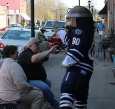 Rowdy the Warrior works Trade Street giving high fives to visiting merchants.
 
