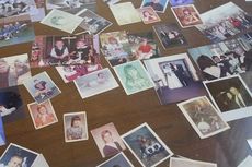 Photos are displayed under a glass on a desk of  customers of the B.A. Bennett Insurance Agency. Many are from children of original customers who are now grown with families of their own.