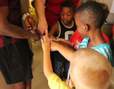 Students had their eyes and hands on the Olympic Silver medal Manteo Mitchell brought to Crestview Elementary Monday.
 
 