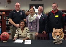 Coaches join Courtney Robinson at the signing.
 
