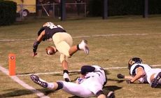 Adrian McGee dives into the end zone for one of his three TDs. Chapman players are left in his wake.
 