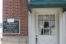Storefront of the historic building that houses the B.A. Bennett Insurance Agency at the point of Trade and Poinsett Streets.