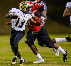 Greer's Camron Kelley tries to ward off a Greenville defender.
 