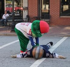 Reedy Rip'It attends to Rowdy the Warrior in the middle of Trade Street after a grueling visit to Greer Tuesday night.
 