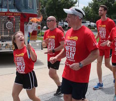 Natalie Dopp leads this leg of the Special Olympics Unified Relay Across America Flame of Hope torch relay as it makes it way through Greer en route to Los Angeles.
 
 
 
 