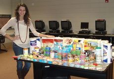 Alyson Craig, President of the Blue Ridge High chapter of FBLA shows the goods received from a Halloween Photo Costume Contest and Drive to benefit the Greenville Humane Society last month.