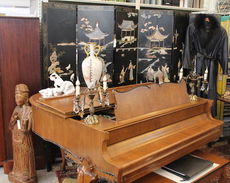 A baby grand piano is part of the furnishings.
 
 