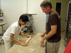 Bassam Soumsoum tries his hand working with dough.