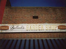 Sign above Bullock's Barber Shop is missing