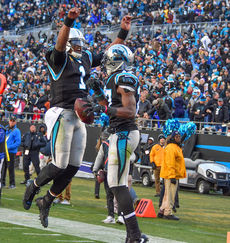 Quarterback Cam Newton (1) is in a celebratory mood after a Panthers touchdown.
 