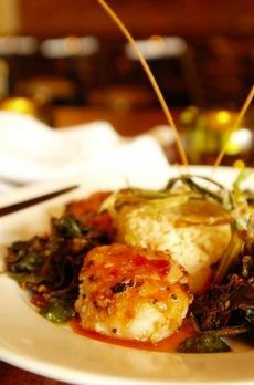 Candy of the Sea displays sea scallops on a bed of sauteed greens.