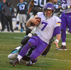 Minnesota quarterback Case Keenum is dragged down for one of six sacks recorded by the Panthers.
 