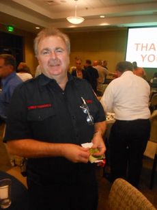 Fire Chief Chris Harvey took home gift cards worth $375 for fire department personnel who could not attend tonight's dinner honoring public safety officials.