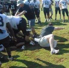 Greer Head Coach Will Young found himself on the ground when he tried to separate players at the end of this play. Young said he  enjoyed the players' intensity during the first day of spring contact drills.
