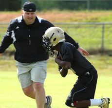 Greer Head Coach Will Young gets in on the action during a spring drill last week. The Yellow Jackets spring scrimmage is scheduled for Saturday, May 18, at 3 p.m. at Dooley Field.
 