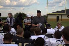 Greer Head Coach Will Young goes over the rules with the players before the start of the scrimmage.